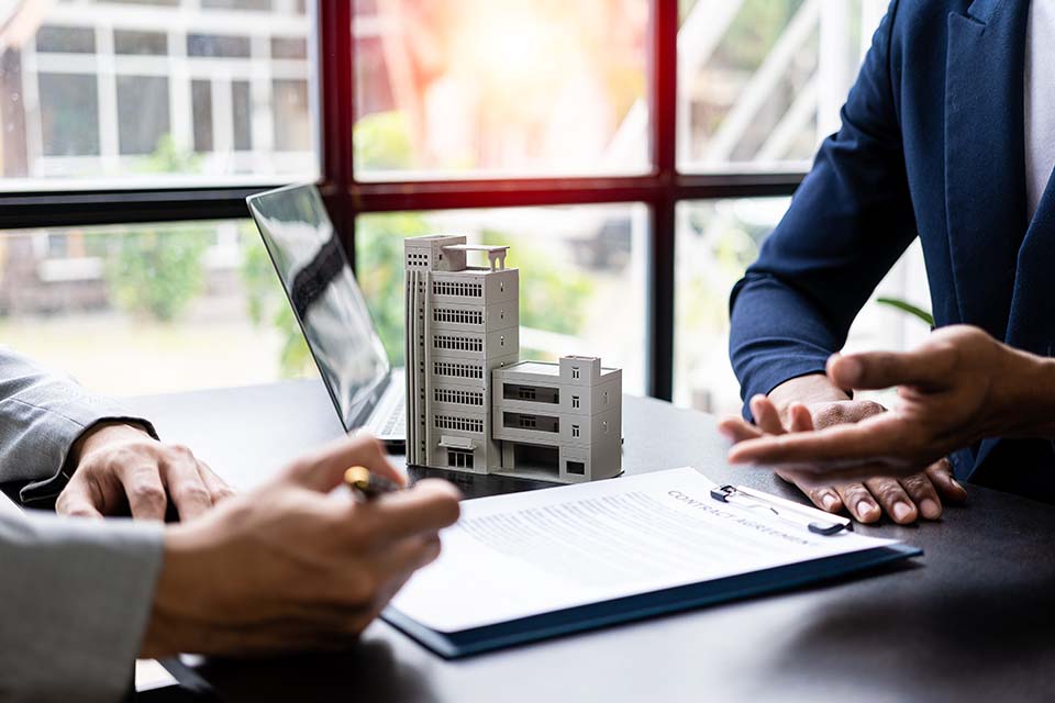 The home broker recommends the client to sign the contract,Real estate concept.Real estate agents are recommending to provide information about housing to customers. Buy house, real estate concept.